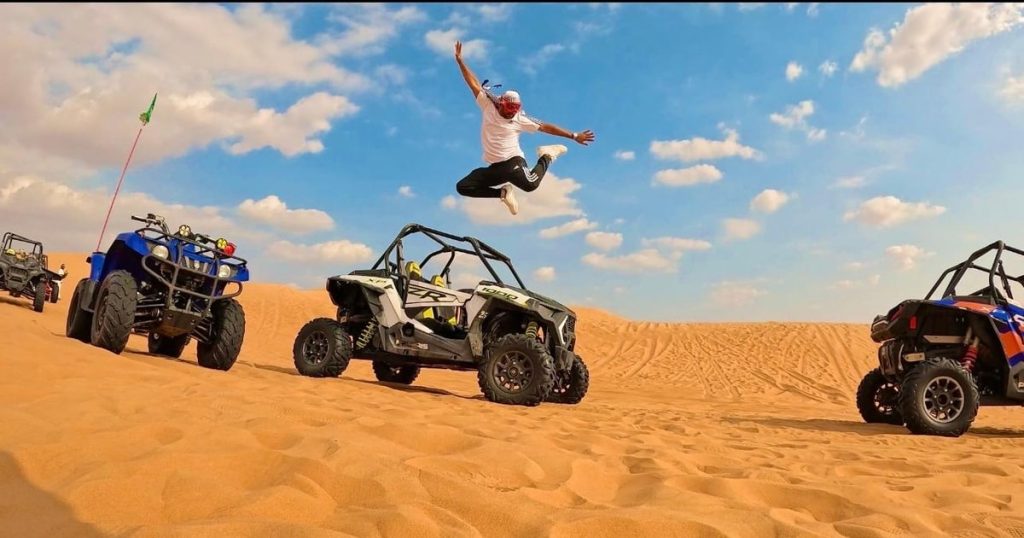 Group of friends enjoying a dubai desert buggy tour with multiple vehicles