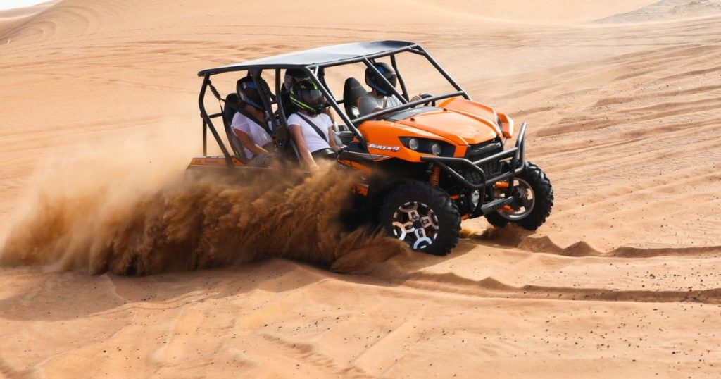 comparing dune buggy and sandboarding in Dubai