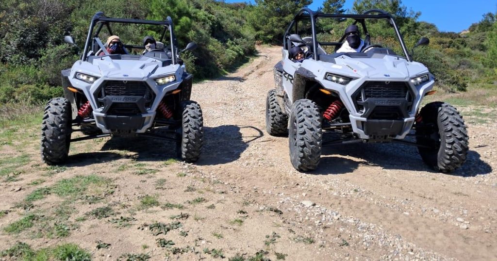 Polaris RZR buggy climbing a sand dune in Dubai