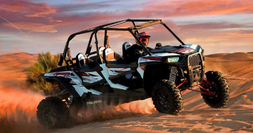 4 seater Polaris buggy riding across Dubai Red Dunes