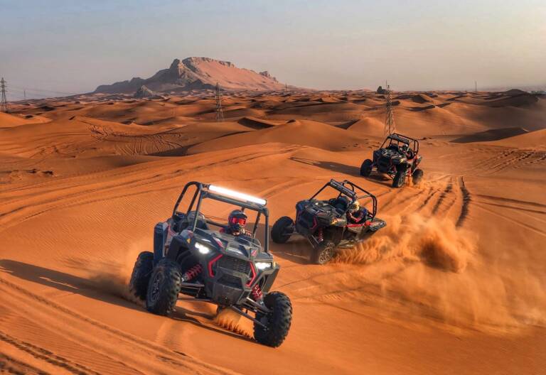 Beginner enjoying sandboarding in Dubai desert