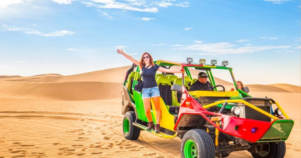 family riding a Polaris 4 seater buggy in Dubai desert