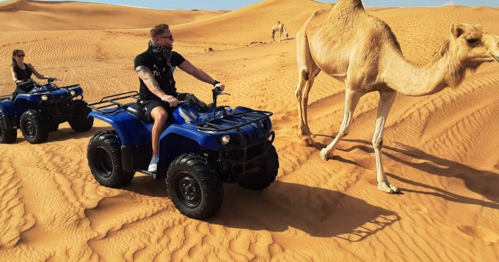 Dune buggy and camel on Lahbab Red Dunes Dubai