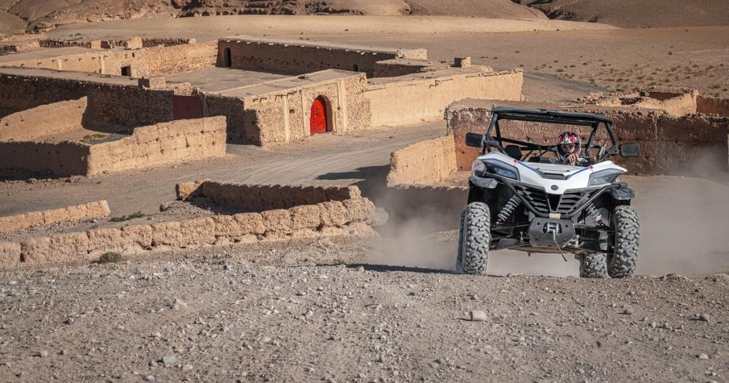 Buggy driving through red dunes in Lahbab Desert Dubai