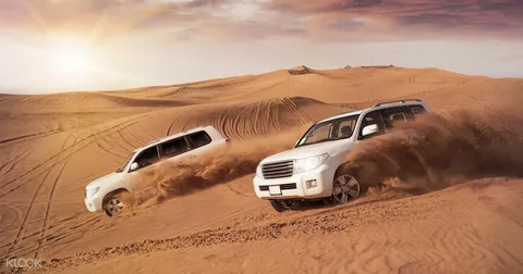 Sandboarding in Dubai on the red dunes of Lahbab Desert